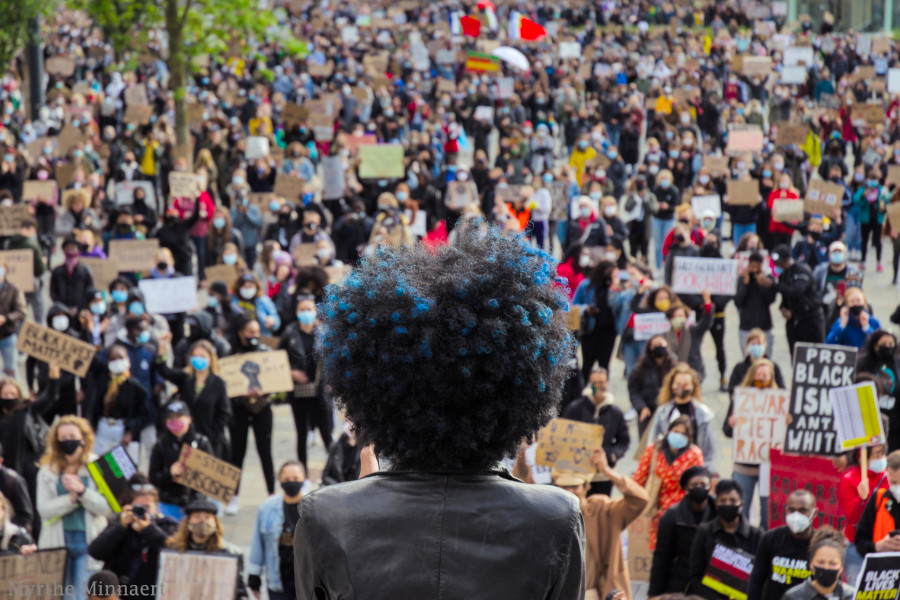 Sylvana Simons (Zwarte vrouw met afro-kapsel) spreek menigte toe